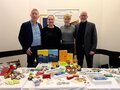 64. Deutscher Verkehrsgerichtstag Mehrere Teilnehmende stehen hinter einem Stand von VOD und HSPV NRW.